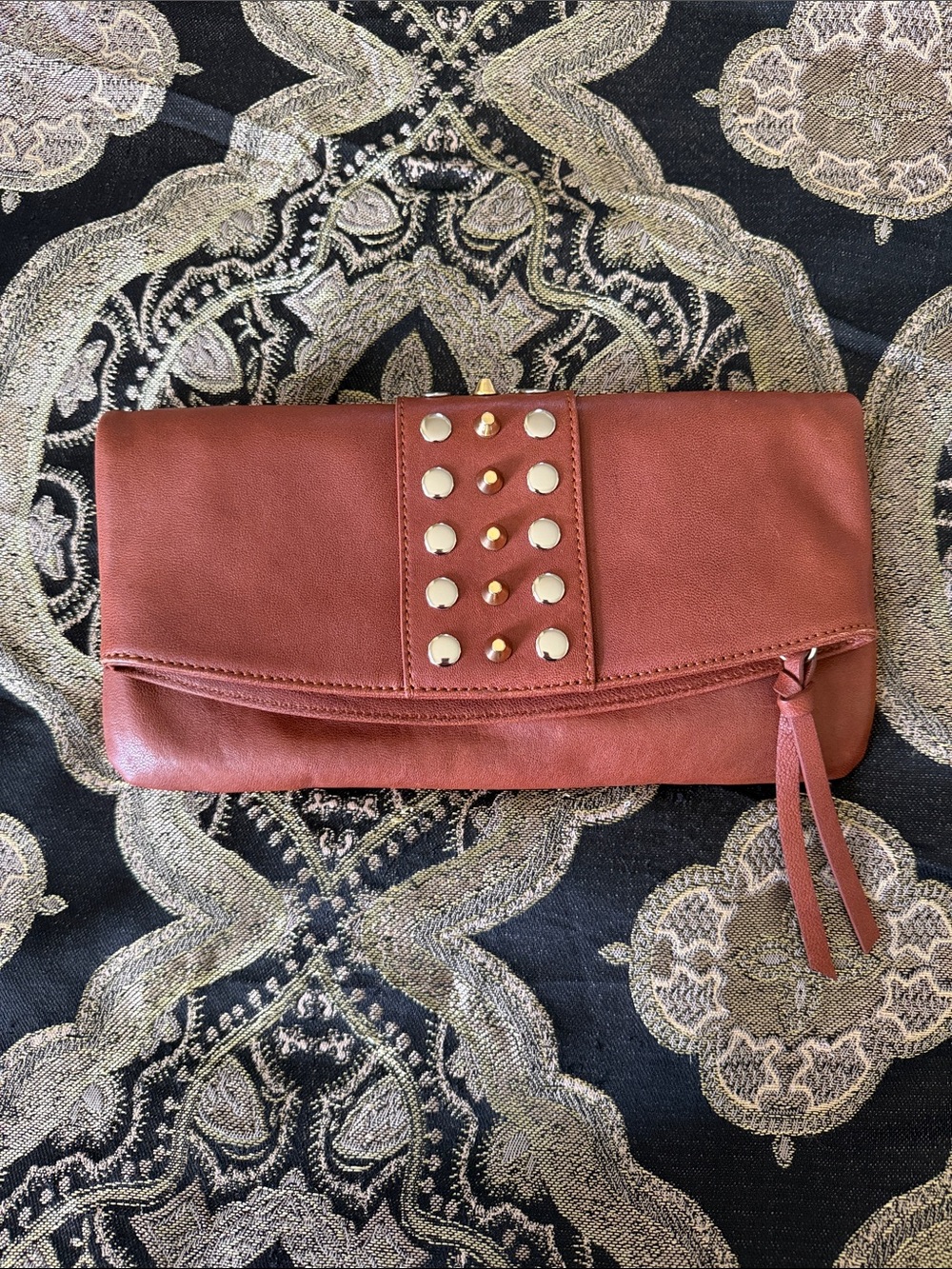 Sorial Rust Studded Fold-Over Clutch with Tassel